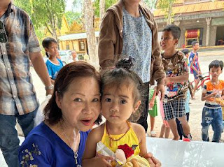 IEP volunteer Thanh Mai Phan with a child from the temple at Xã Tân Mỹ, Vietnam.