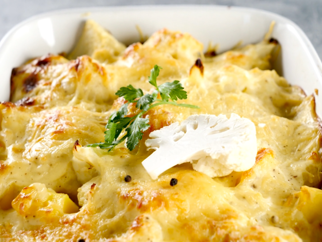 Cauliflower Cheese baked in white corning dish garnished with parsley