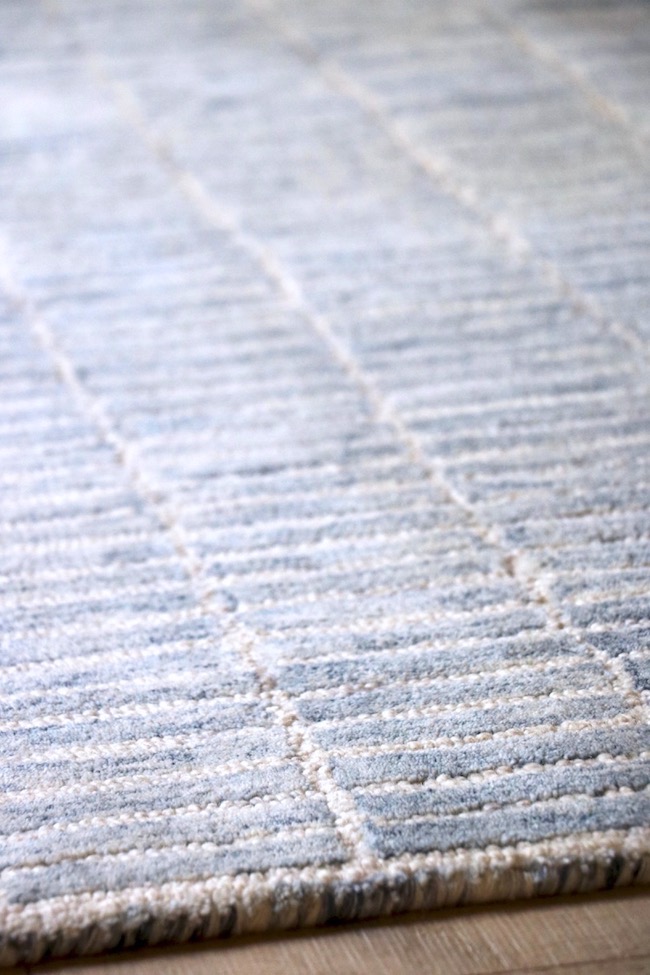 Variations in the blues of the wool rug mean the rug blends with a wide range of blues.