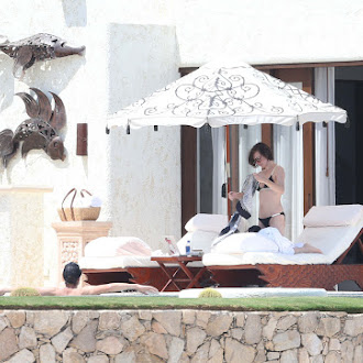 Milla Jovovich seen in bikini poolside while on vacation_42.jpg