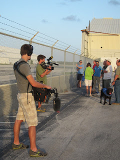 Shot of the sound guy shooting the puppy raisers and pups watching the helicopter. Photo by Carolyn Hersh.