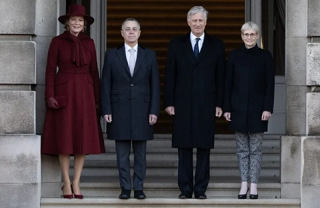 Queen Mathilde wore a wine red burgundy coat and wine red burgundy dress by Naatan. First Lady Paola Rodoni Cassis