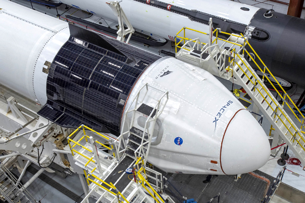 The Crew Dragon Demo-2 capsule is attached to its Falcon 9 rocket inside SpaceX's Horizontal Integration Facility...on May 20, 2020.