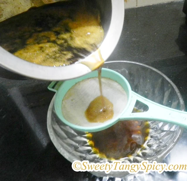 A saucepan with melted jaggery forming a rich syrup.