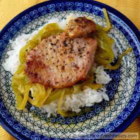 Pork chops baked with curry-seasoned green tomatoes and onions served over rice.