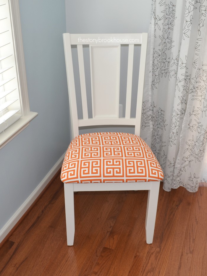 Colorful seat cover on new white dining chairs