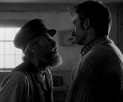 The Lighthouse 2019 movie scene showing Thomas Wake (Willem Dafoe) confronting and yelling at Ephraim Winslow (Robert Pattinson)