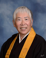 Female Buddhist Minister in Black Robes and yellow wagesa