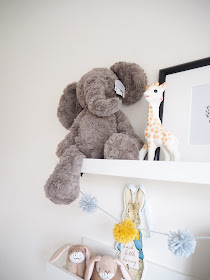 Gender neutral nursery room for a new baby boy or girl, in colour scheme grey and yellow featuring handmade accessories and interiors