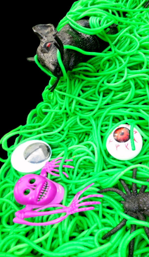 Take play-time up a notch and make Halloween goblin guts for kids!  This gooey slime is made from spaghetti. #goblinguts #spaghettirecipes #spaghettislime #halloweenspaghetti #halloweensensorybin #halloweensensoryactivities #spookyspaghetti #howtodyespaghettinoodles #sensoryactivities #sensorybins #growingajeweledrose