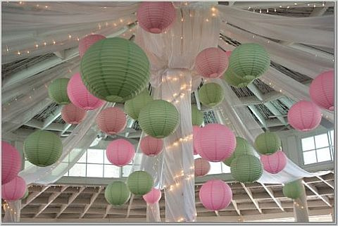 Green and pink wedding lanterns hanging on the ceiling