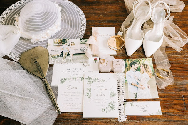 wedding details flatlay with lace and wedding invitations