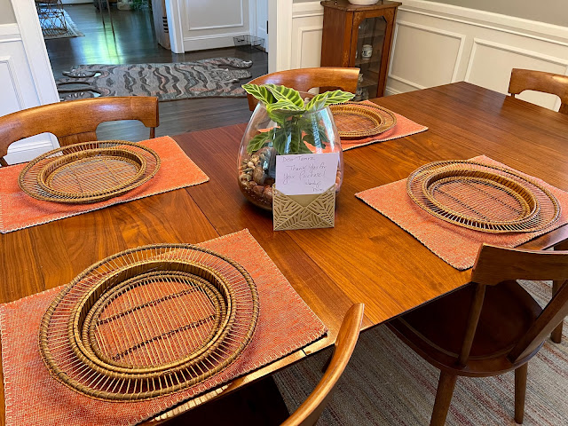 dining table with placemats and terrarium