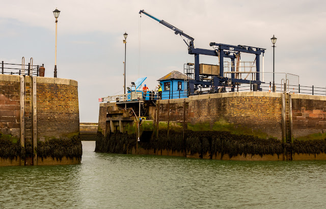 Photo of staff fitting the new gate cable at Maryport Marina