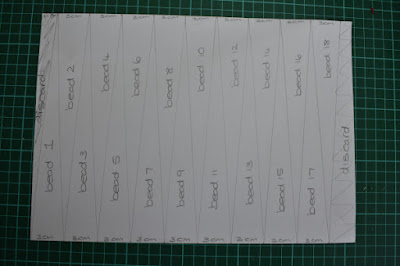 Cutting lines drawn onto pencils marks for paper beads