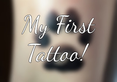 Text "My First Tattoo!" with faded image of a pawprint tattoo in the background