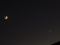 Wide angle photo of a crescent moon (left) and Venus and Saturn (right)