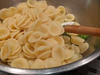 Orecchiette with radish pesto - adding the sauce to the pasta.