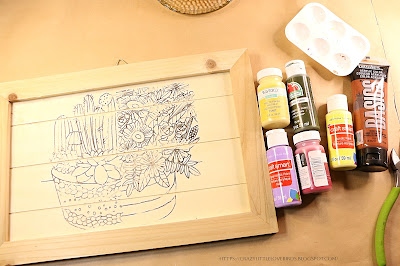 Succulent rub on transfers on wooden board near acrylic paint on a table