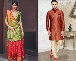 a woman in red,green saree and a man in a red sherwani and offs white pajama
