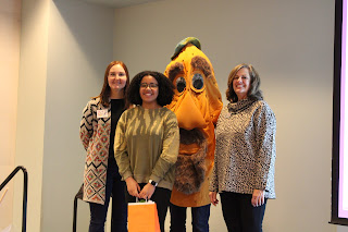 an art teacher, a student, a YAM mascot, and KAEA president pose for a picture