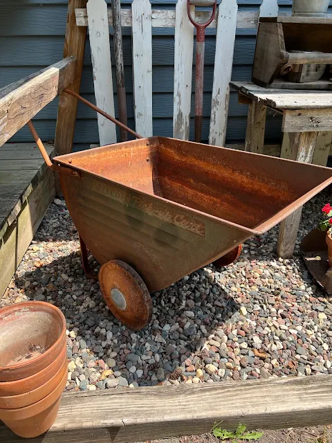 Photo of a rusty vintage garden cart.