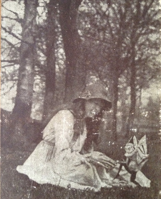 The second of the five Cottingley Fairies photographs, showing Elsie with a winged gnome, picture from the front cover of The Coming of the Fairies by Sir Arthur Conan Doyle