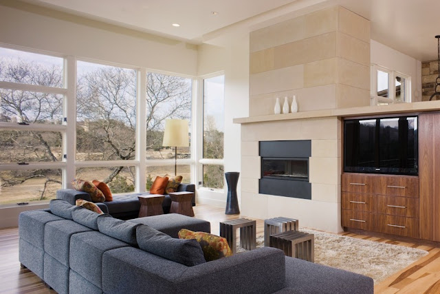 Photo of large modern living room with huge windows and view of the nature