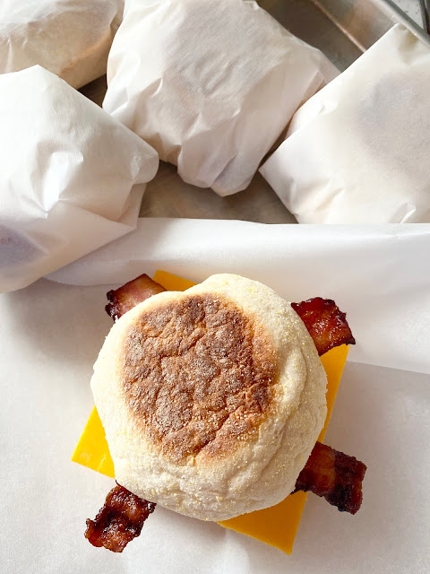 Breakfast Sandwiches wrapped in parchment paper.