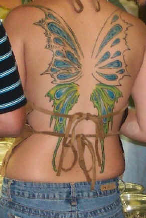 Female Tattoo With Japanese Koi Fish Tattoo Design On The Upper Back