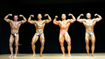 Competitors posing in a bodybuilding competition