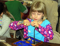 Children learn how to tie dry flies