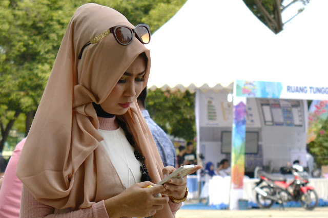 Women and Gadgets "at a fashion show contest and hijab creations