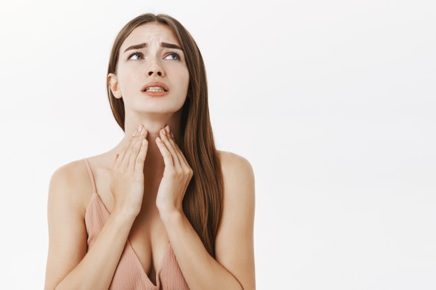 Woman check Her Neck for Hypothyroidism