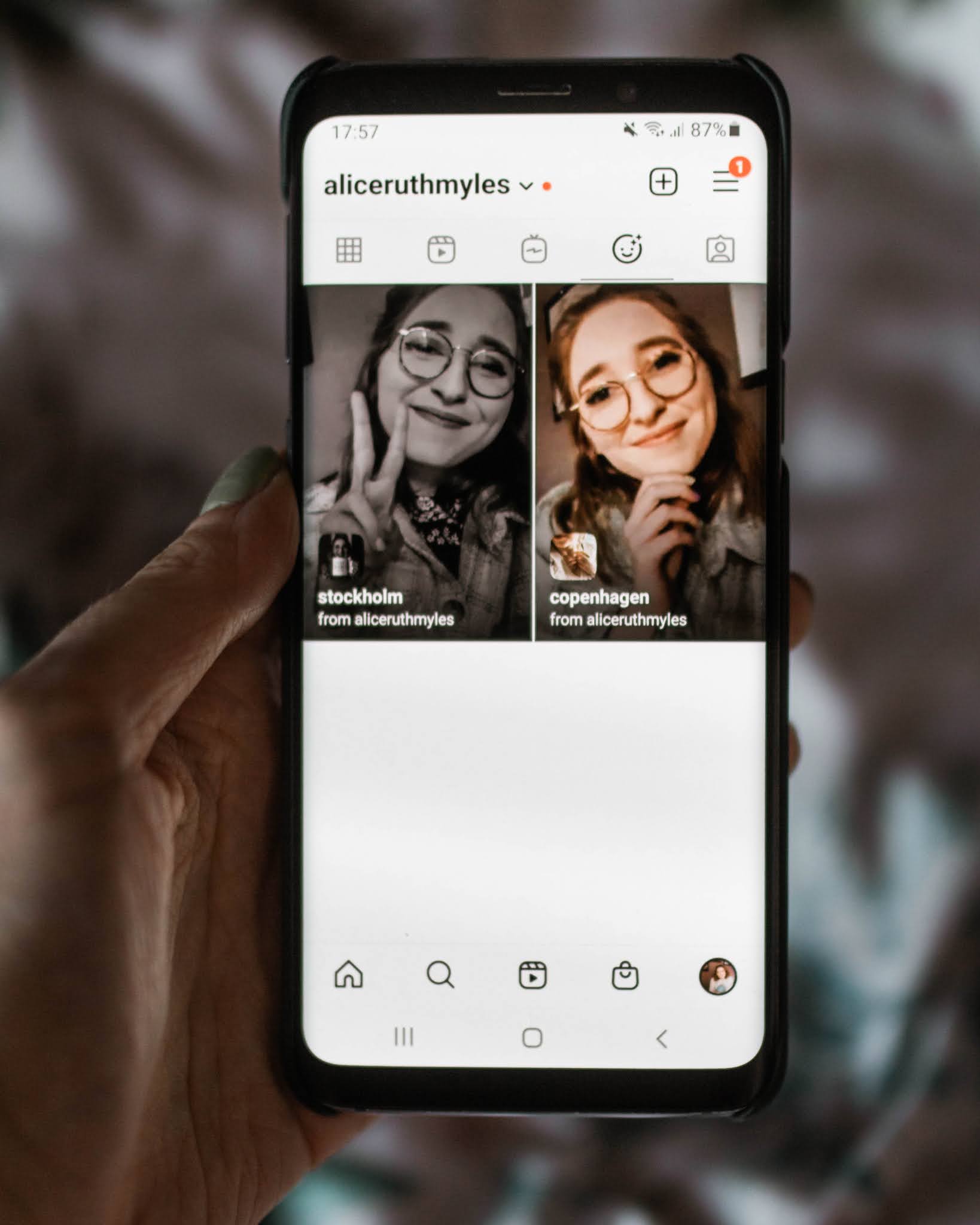 holding phone showing instagram story filters