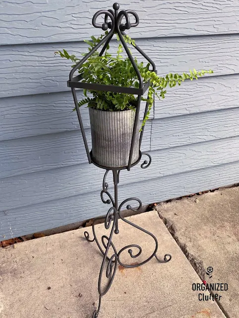 Photo of a candle holder repurposed as a fern stand.