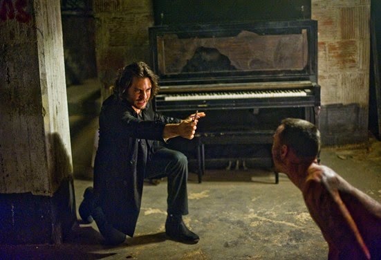Mendoza (EDGAR RAMIREZ) holds off a possessed Jimmy (CHRIS COY) with the power of the crucifix, prayer and holy water in Screen Gems' DELIVER US FROM EVIL.