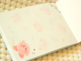 A photo showing a notepad, the pages decorated with kirby illustrations