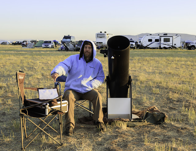 Wes Stone next to 10" Dobsonian telescope; folding chair holds an accessory case and sketch paper on clipboard.