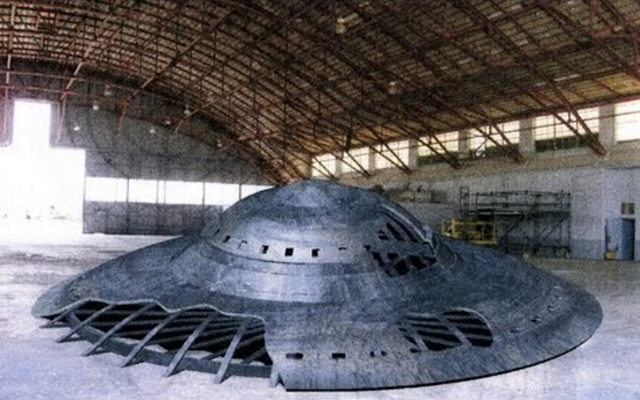 UFO or Flying Saucer inside a warehouse type building.