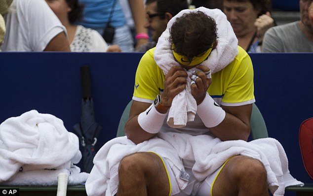 Defending champion Nadal covers his eyes with his towel during his lost to Austrian youngster, Thiem