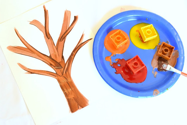 LEGO Stamped Fall Tree Craft for Kids. Use LEGO or DUPLO bricks to paint leaves in beautiful fall colors! Fun autumn printmaking activity for preschool, kindergarten, or elementary.