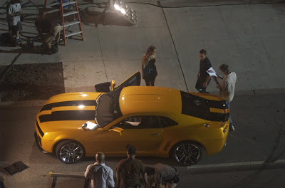 Transformers 2 - Michael Bay standing outside along with Shia LaBeouf, Isabel Lucas and the Bumblebee Camaro