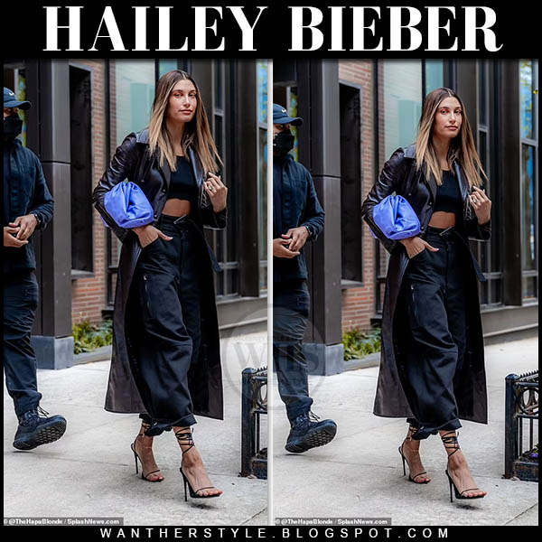 Hailey Bieber in long coat, sandals with purple clutch