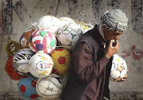 Afghan man carries balls to sell,