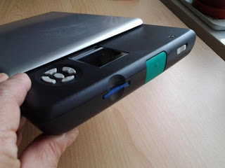 Shiney thing from the side, as it says in the caption you can see the blue card in the slot, the large green scan button and the smaller grey slide button for the power.