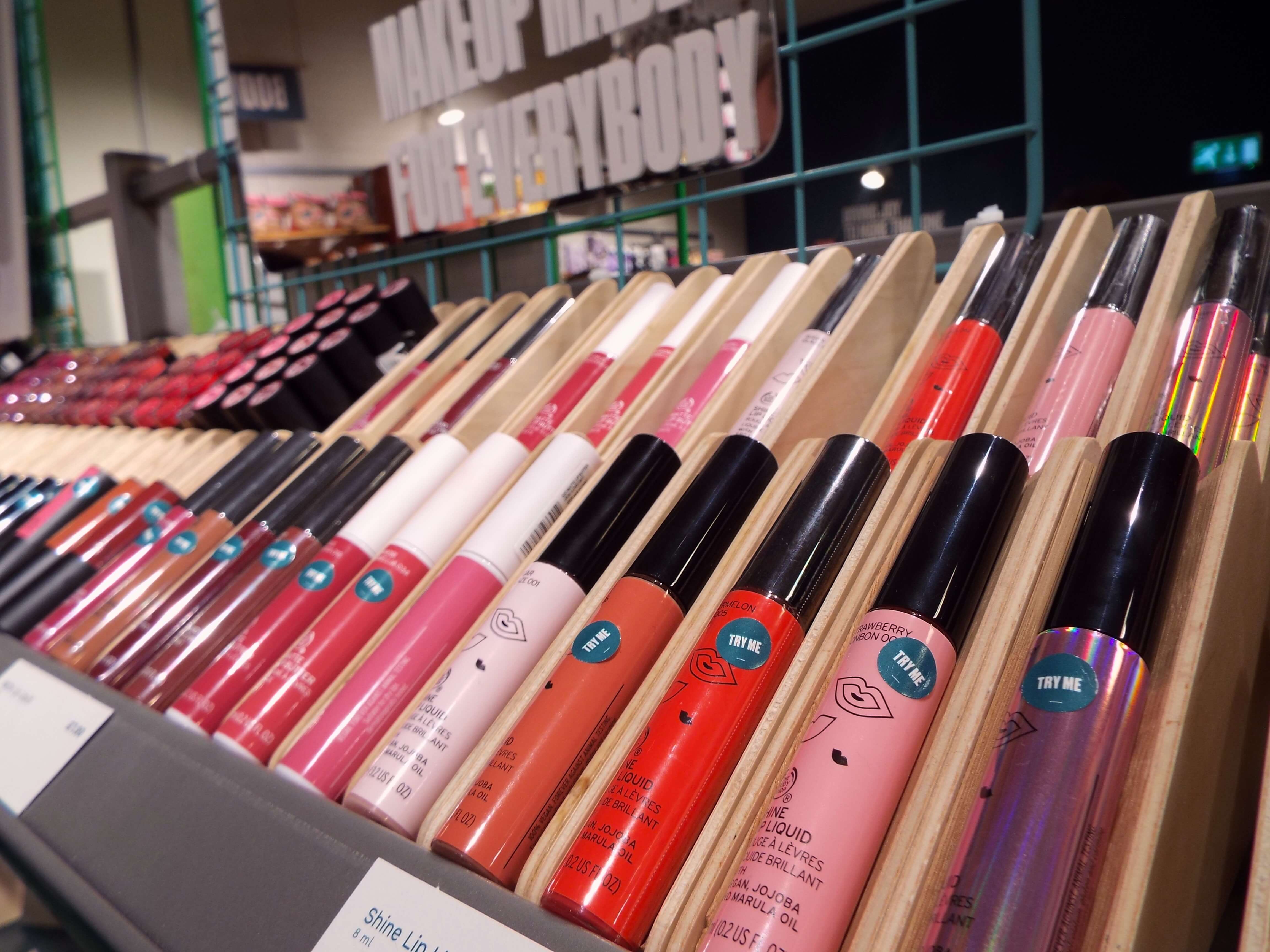 An array of The Body Shop liquid lipsticks and other lip products on display.