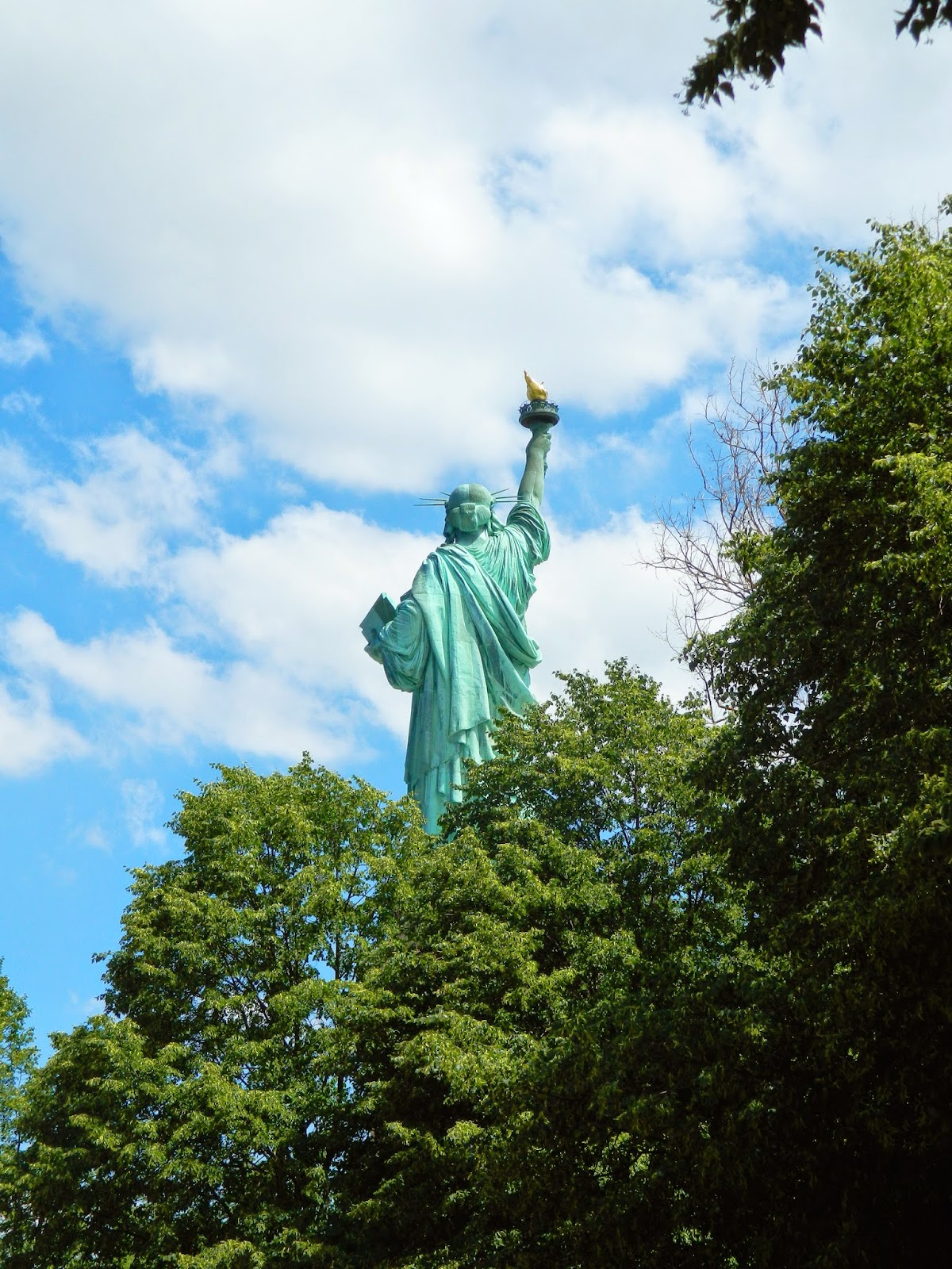 new york city statue of liberty clear day beautiful sun behind