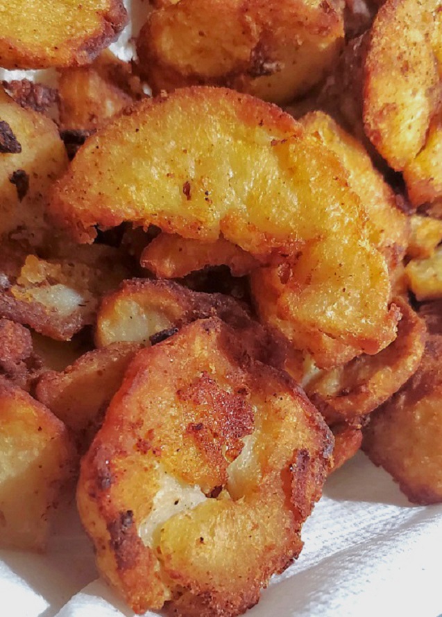 this is a dish of crispy fried home fried slices of potatoes