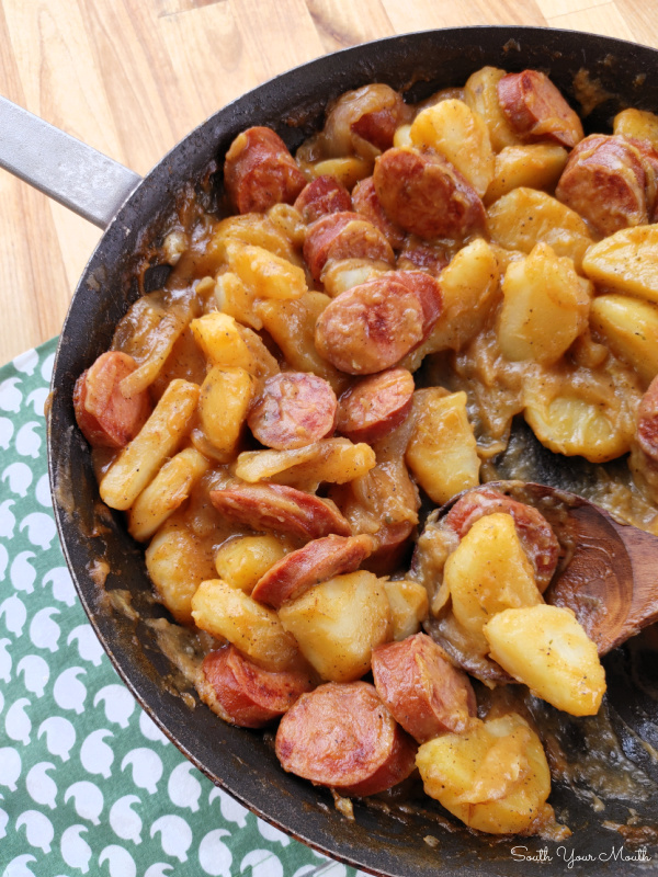 Southern Smothered Sausage & Potatoes! An old-fashioned country recipe with smoked sausage and onions smothered in stewed potatoes for a simple, hearty homemade meal that comes together in under 30 minutes.